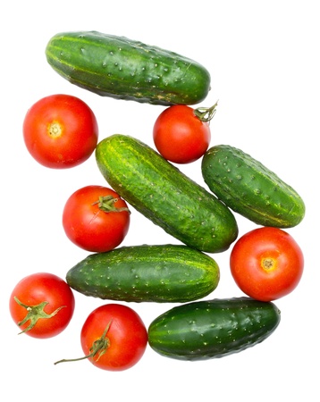 cucumbers and tomatoes isolated on whiteの写真素材