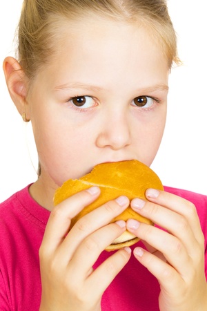 Happy Little Girl Eating Hamburger.の写真素材