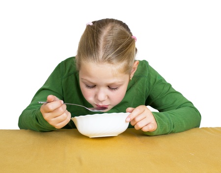 Girl eats isolated on whiteの写真素材