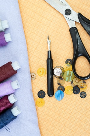 Sewing supplies: thread, scissors, buttons