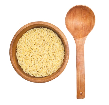 rice in wooden plate and spoon isolated on white backgroundの写真素材