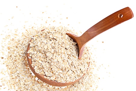 oats in wooden bowl on wooden boardsの写真素材