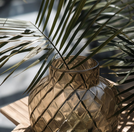 medium palm leaves in a glass vaseの素材