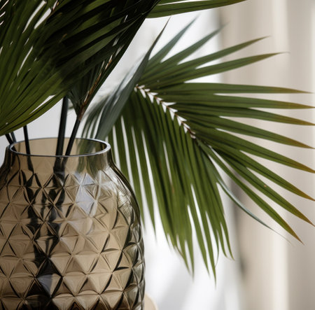 medium palm leaves in a glass vaseの素材