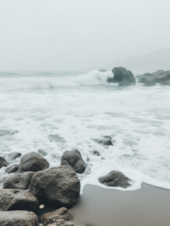 ocean waves on the beach with some rocks,の素材