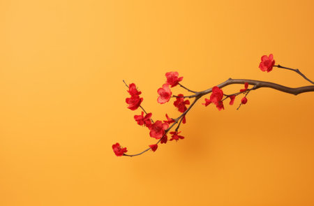 red blossom with branch isolated on yellow background.の素材