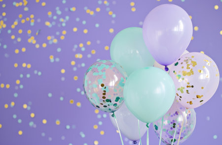 pastel and aqua balloons with confetti on purple background.の素材