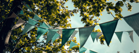 colorful flags hanging on colored bunting.の素材