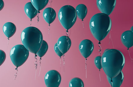 blue helium balloons suspended from a pink ceiling.の素材