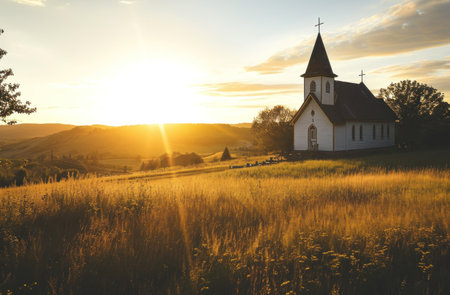 the sun is setting over a country church.の素材