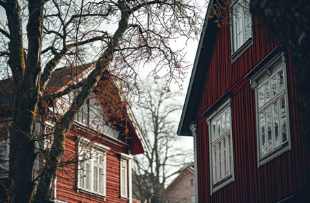 two buildings with red siding and white details.の素材