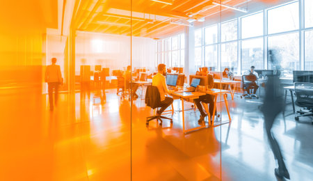 blurred view of a group of people in an office.の素材