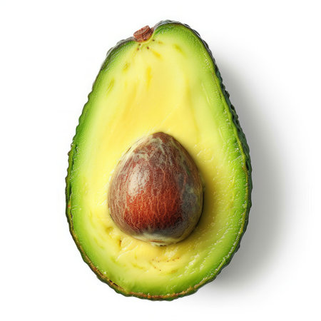 A ripe avocado cut in half, showing its creamy green flesh and smooth skin, set against a clean white background.の素材
