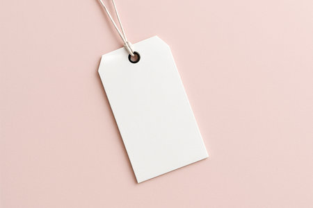 A blank tag lays flat on a soft, light-colored background, ready for use in labeling items or gifts. Its simple design allows for customization and personal touches..の素材