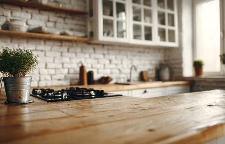 Sunlight streams into a stylish kitchen featuring a wooden countertop, a gas stove, and potted plants. The rustic decor blends elegance with comfort in this inviting space.の素材