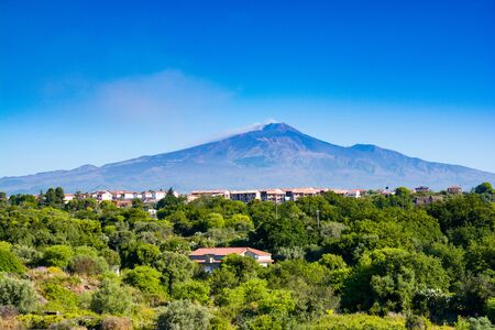 Smoking mount Etna above sicilian cities signs of an eruptionの写真素材