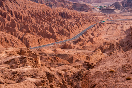 Road to san pedro de atacama surounded by red rocksの写真素材