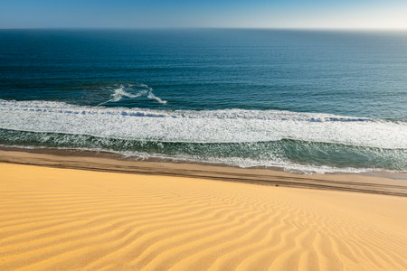 Desert dune ending in the Atlantic ocean near Walvis Bayの写真素材