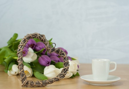 tulips on the table with cup of caffeeの写真素材