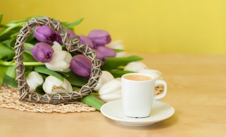tulips on the table with cup of caffeeの写真素材