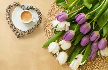 tulips on the table with cup of caffeeの写真素材
