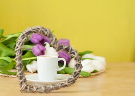 tulips on the table with cup of caffeeの写真素材