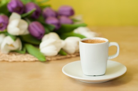 tulips on the table with cup of caffeeの写真素材