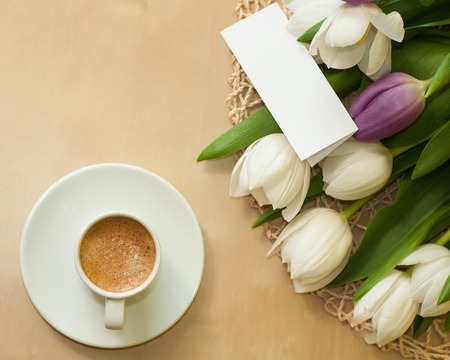 tulips on the table with cup of caffeeの写真素材