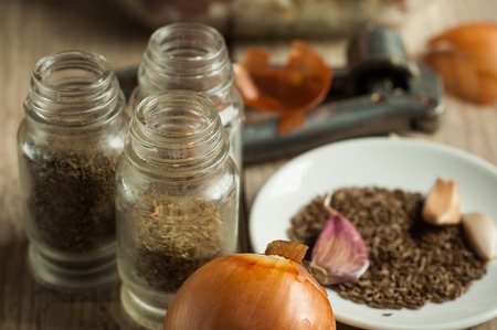 raw rabbit meat in roaster with onion cumin and garlic on wooden vintage tableの写真素材