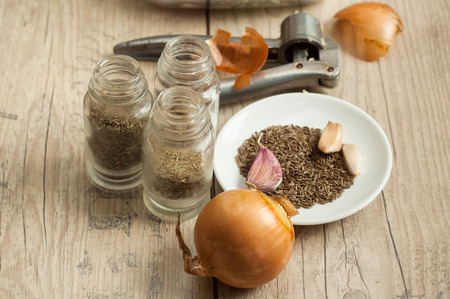 raw rabbit meat in roaster with onion cumin and garlic on wooden vintage tableの写真素材