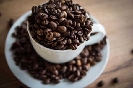 coffee cup filled by coffee beans
