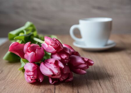 coffee cup with tulipsの写真素材