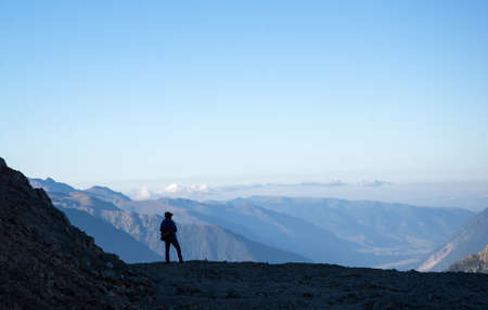 A man looks away at the mountains of the Caucasusの写真素材