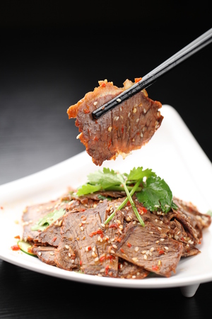 Stir fried spicy meat served on a plateの写真素材