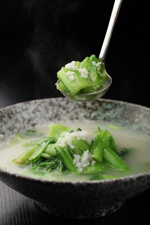 Porridge with vegetable served in a bowlの写真素材