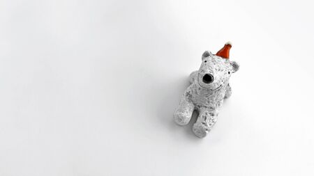 A polar bear doll smiling and wearing a red hatの写真素材