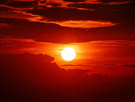 The evening sun in the sky and cloudsの写真素材