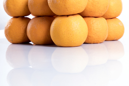 Isolated orange mandarin that is synonymous with the Chinese New Year celebration with shadow  in the white backgroundの写真素材