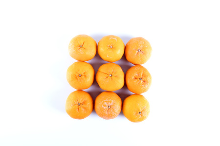 Isolated orange mandarin that is synonymous with the Chinese New Year celebration in the white backgroundの写真素材