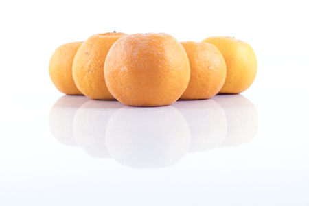 Isolated orange mandarin that is synonymous with the Chinese New Year celebration in the white backgroundの写真素材