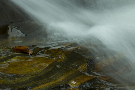 wet rockat the waterfallの写真素材