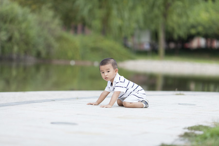 Happy Chinese baby boy playing in a park, shot in Beijing, Chinaの写真素材