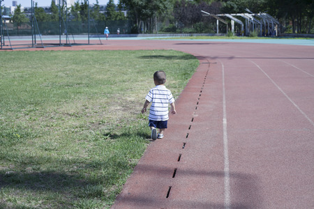 Cute Chinese baby boy playing in a stadium, Beijing, Chinaの写真素材