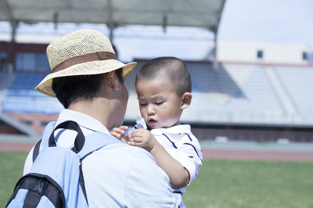 Chinese father and son playing in a stadium, Beijing, Chinaの写真素材