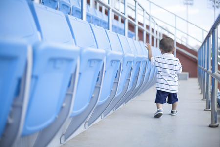 Cute Chinese baby boy playing in a stadium, Beijing, Chinaの写真素材