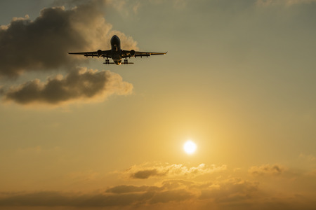 sun and sunset with aircraft landing