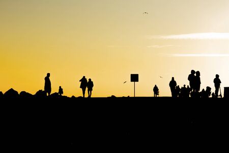 people silhouettes at sunset in nature