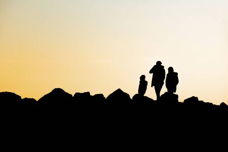 people silhouettes at sunset in natureの写真素材