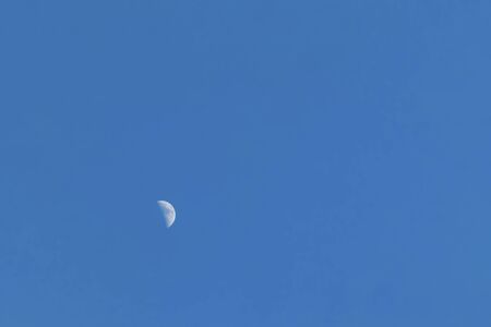 half moon at the blue skyの写真素材