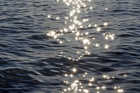 evening sun and sparkles in the seaの写真素材